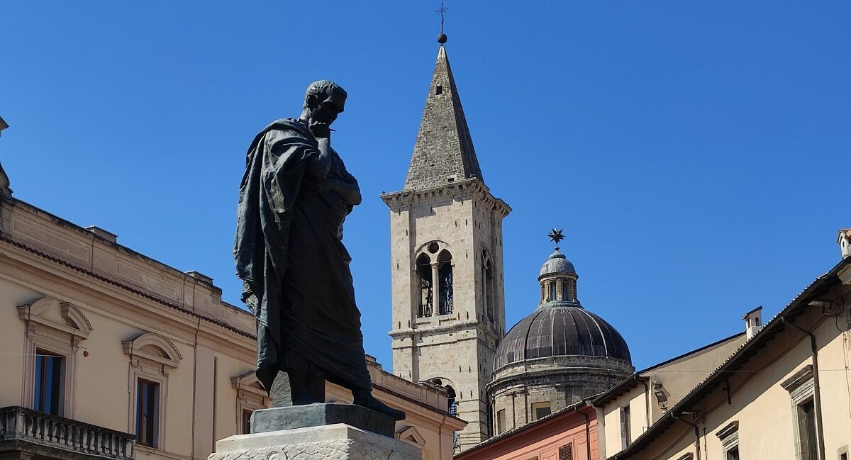 Statue of Ovid with church spire in background