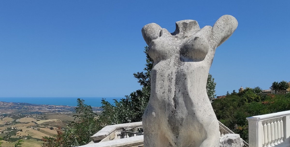 scultpure with countryside and sea in background, Atri