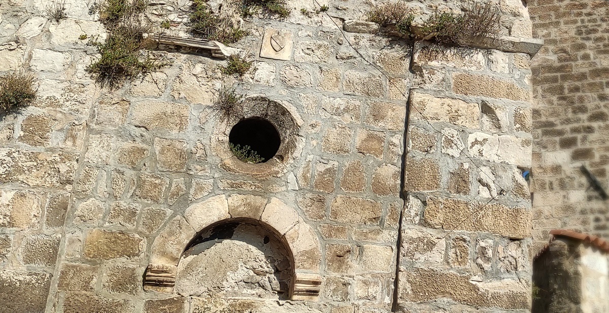 Detail of wall of San Nicola with rose window and crest, Cocullo