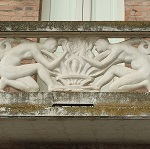 Crouching figures in sculpted balustrade