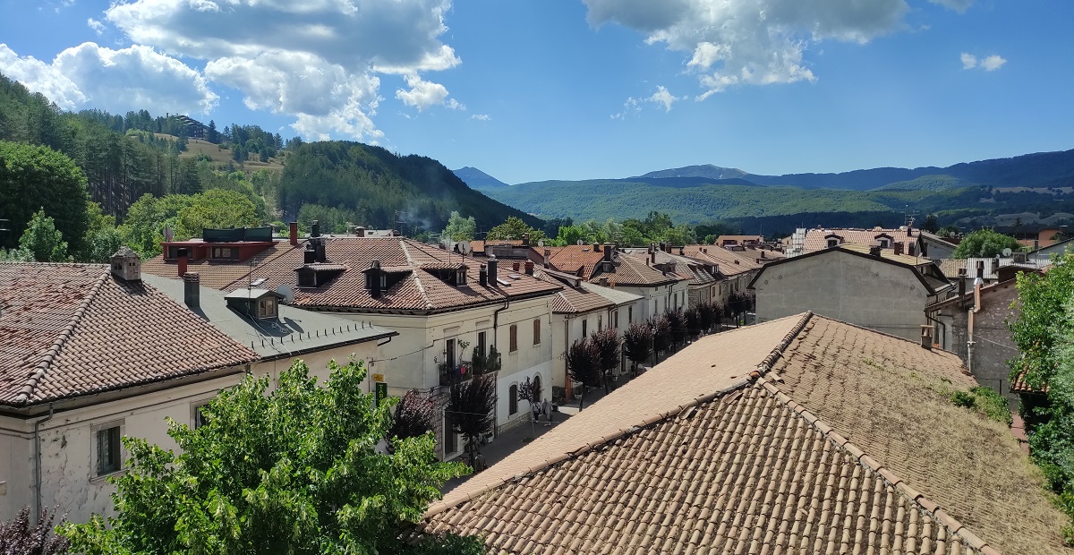 View of rooftops of Pescasseroli and mountains beyond from windows of Palazzo Sipari