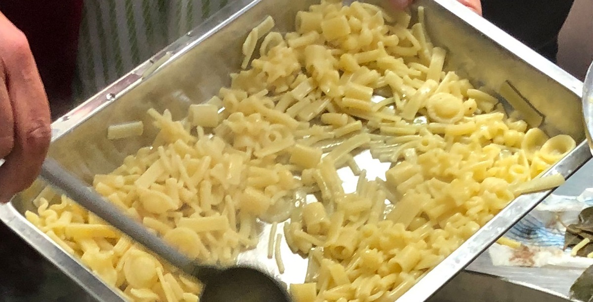 tray of pasta and ladle 