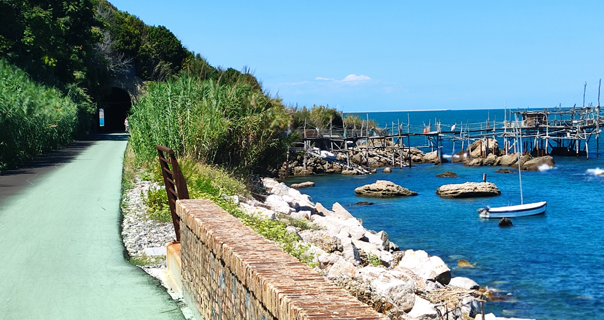 Bike path with sea and trabocco and boats